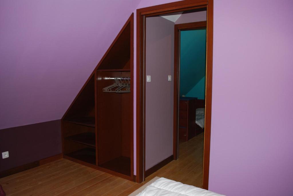 a closet in a room with a staircase and a mirror at la grange in Wintzenheim