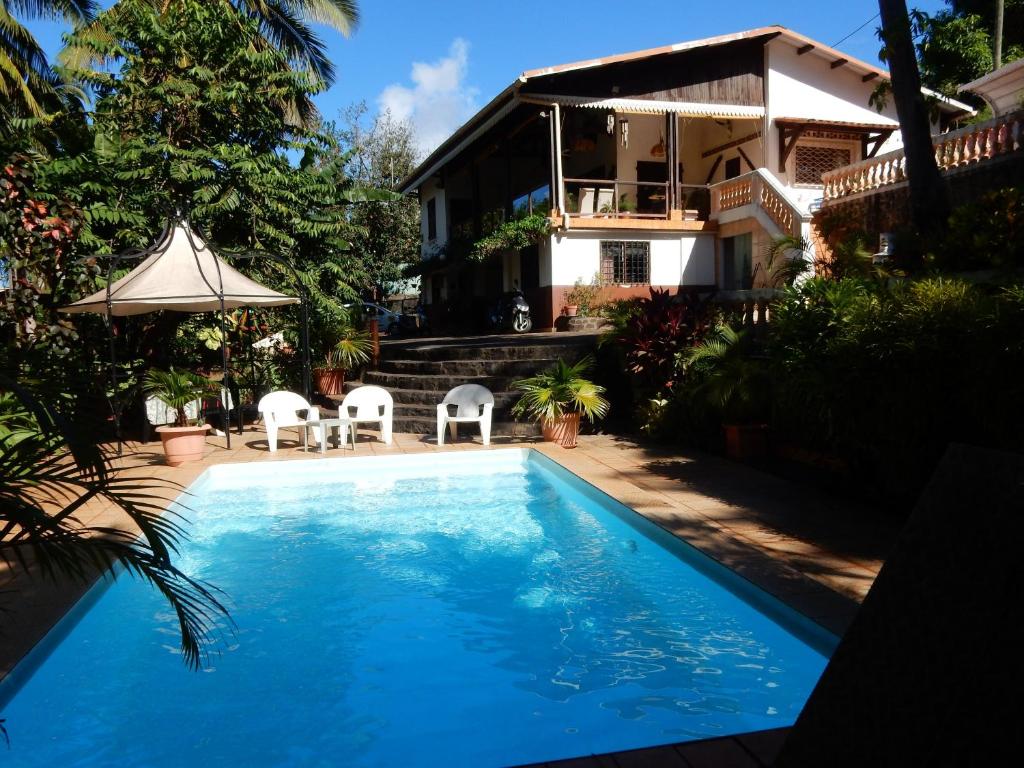 a swimming pool in front of a house at Sarl Mayoume in Mamoudzou