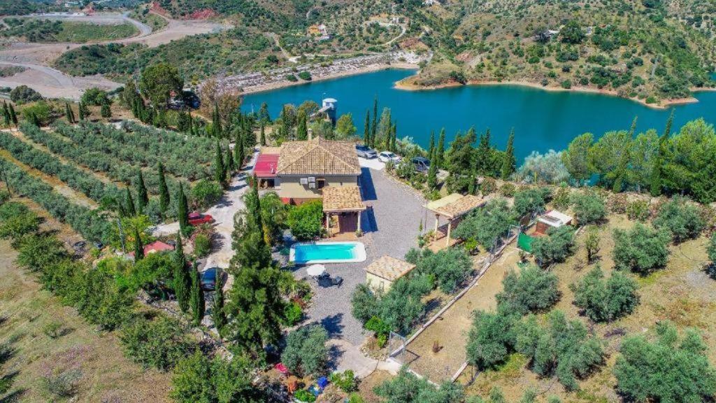 an aerial view of a villa with a lake at finca mallorquin in Málaga