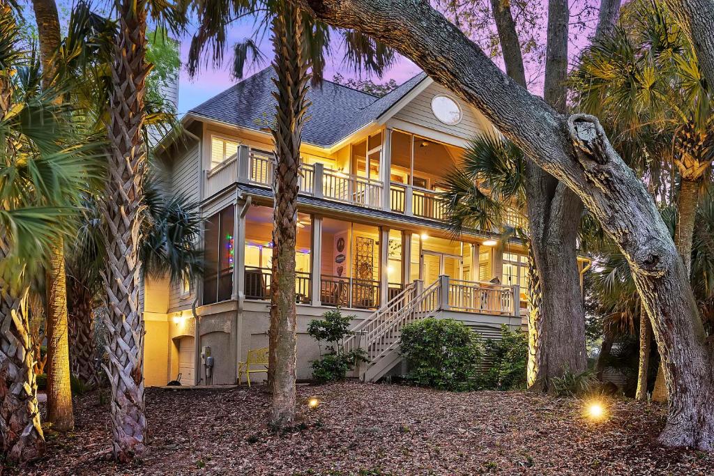 a house with palm trees in front of it at 23 Ocean Green in Kiawah Island