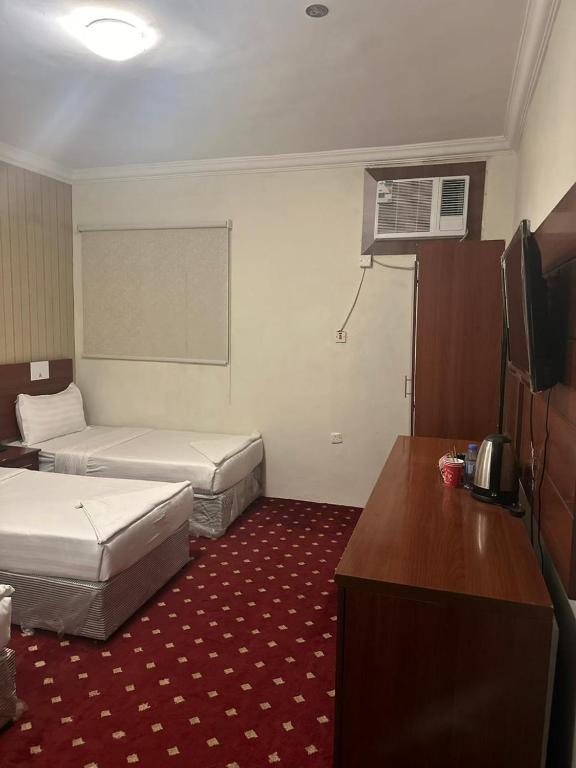Postel nebo postele na pokoji v ubytování فندق كنان العزيزية Kinan Al Azizia Hotel Makkah