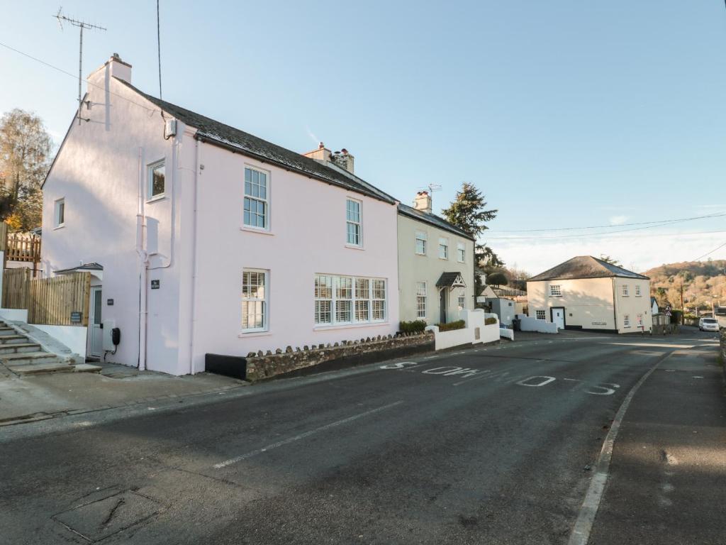 a white house on the side of a street at The Old Stores Annexe in Lyme Regis