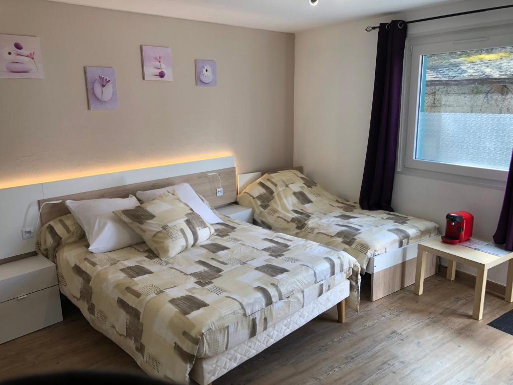 Postel nebo postele na pokoji v ubytování L'auberge fleurie