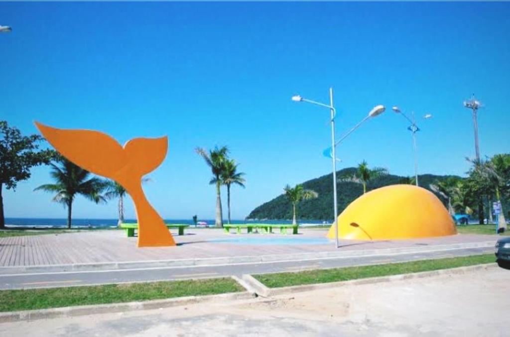 a sculpture of a whale and a yellow dome at Casa de Praia Beira Mar Bali Beach House in Bertioga