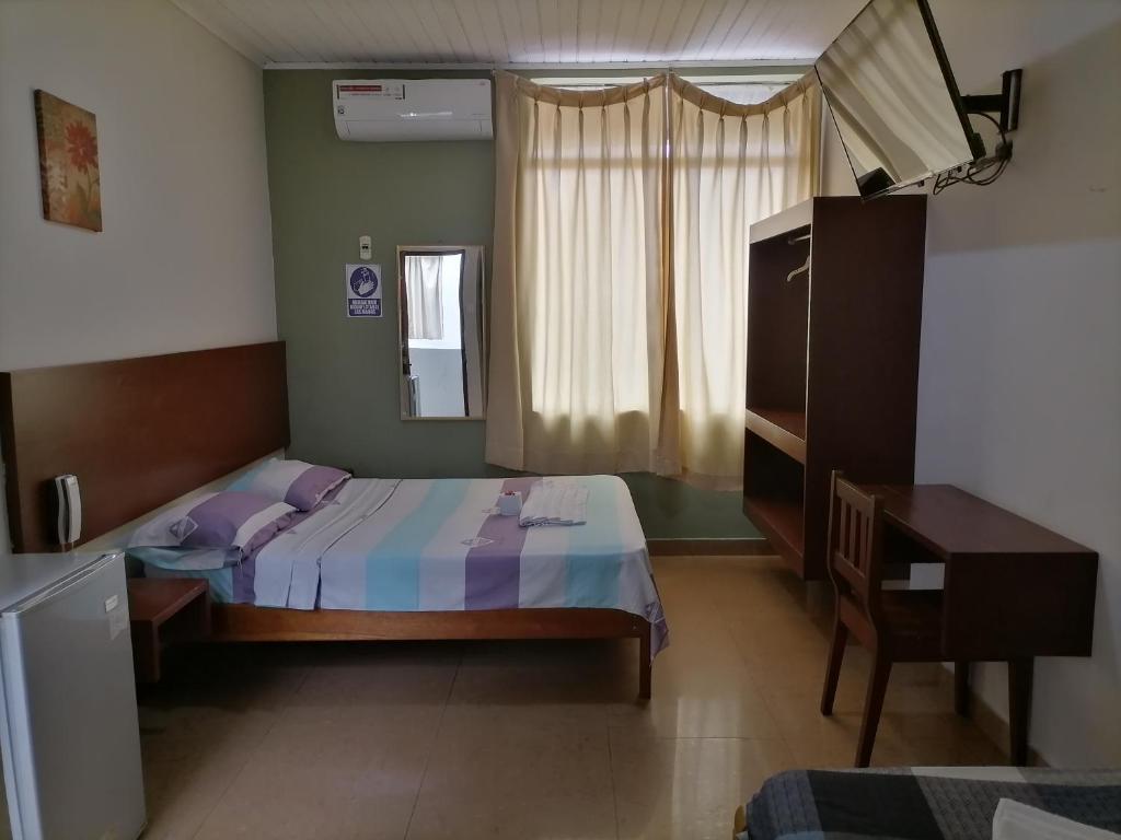En eller flere senger på et rom på Hostal Camu Camu