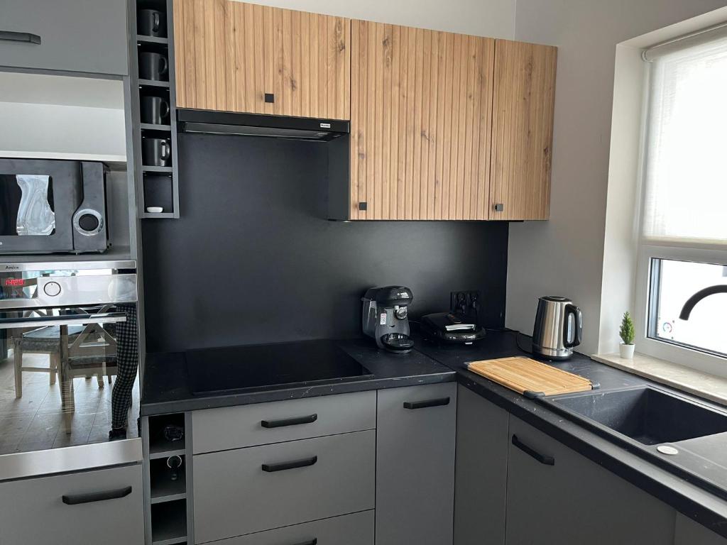 a kitchen with a sink and a counter top at All Season Lasówka in Lasowka