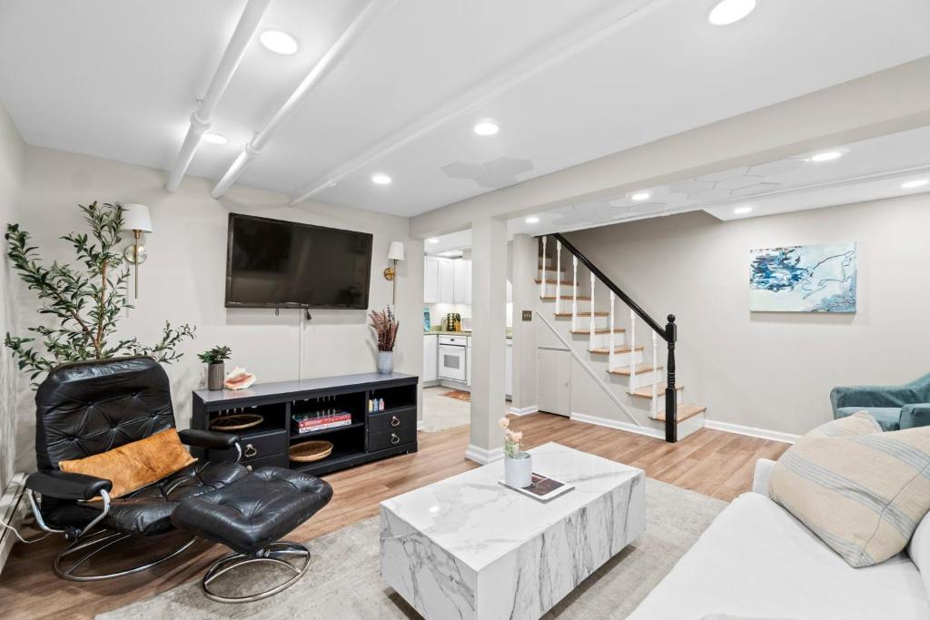 a living room with a couch and a tv at Glover Park/Georgetown Oasis with parking in Washington, D.C.