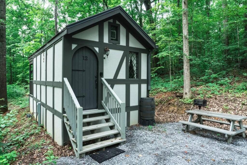 a small shed with a staircase and a bench at Cozy Cabin Near the Smokies #12 Carlotta in Sevierville