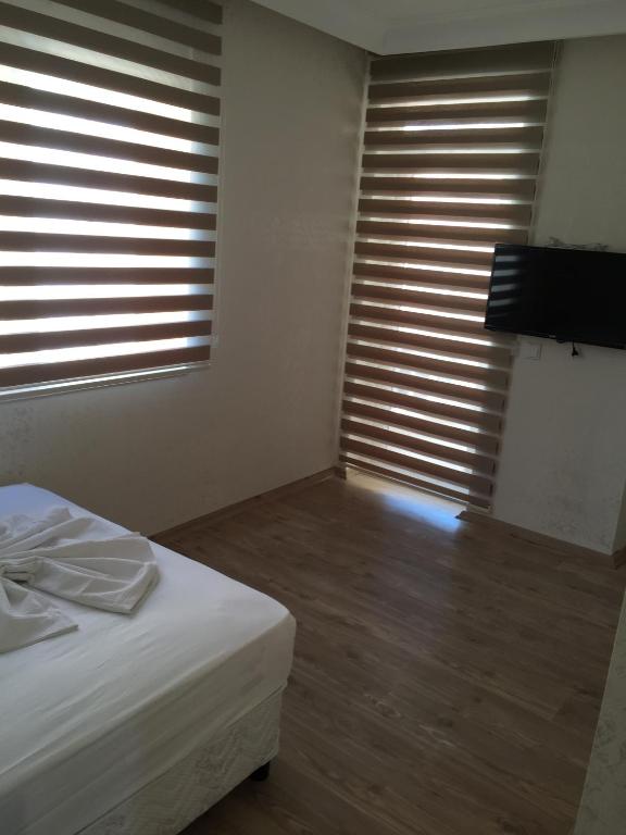 Postel nebo postele na pokoji v ubytování Köşk Hotel