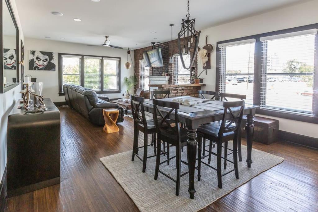 a dining room and living room with a table and chairs at Bison Flat - Redefined Urban Luxury in Tulsa