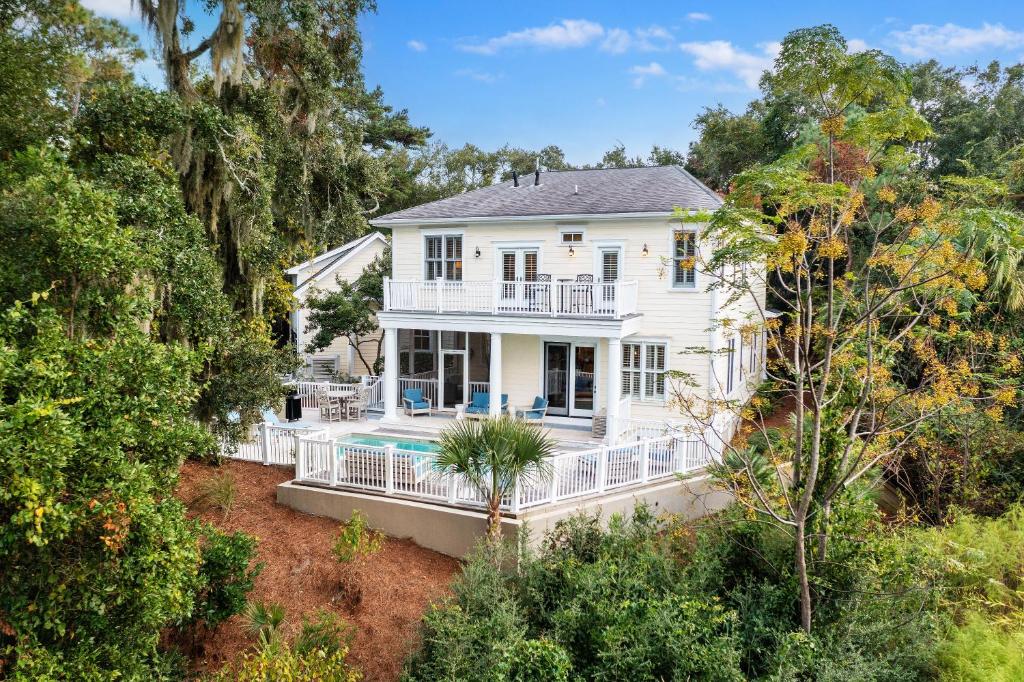 an aerial view of a white house with a pool at 2482 High Hammock Road in Seabrook Island
