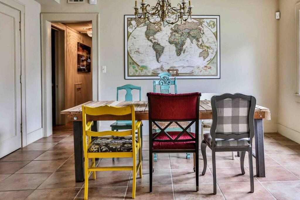 a dining room with a table with colorful chairs at The Teak Follow, beautiful brick enclosed space in Tulsa