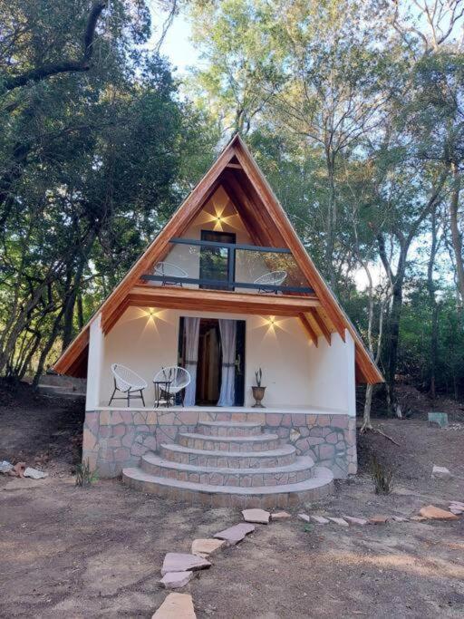 a small house with a staircase and a window at Casa Alpina El Bosque in Independencia