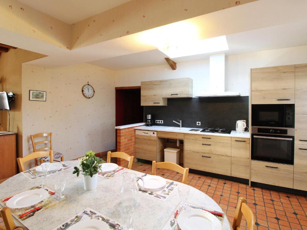 a kitchen with a table and chairs in a room at Gîte Baugé en Anjou, 5 pièces, 9 personnes - FR-1-622-28 in Baugé-en-Anjou