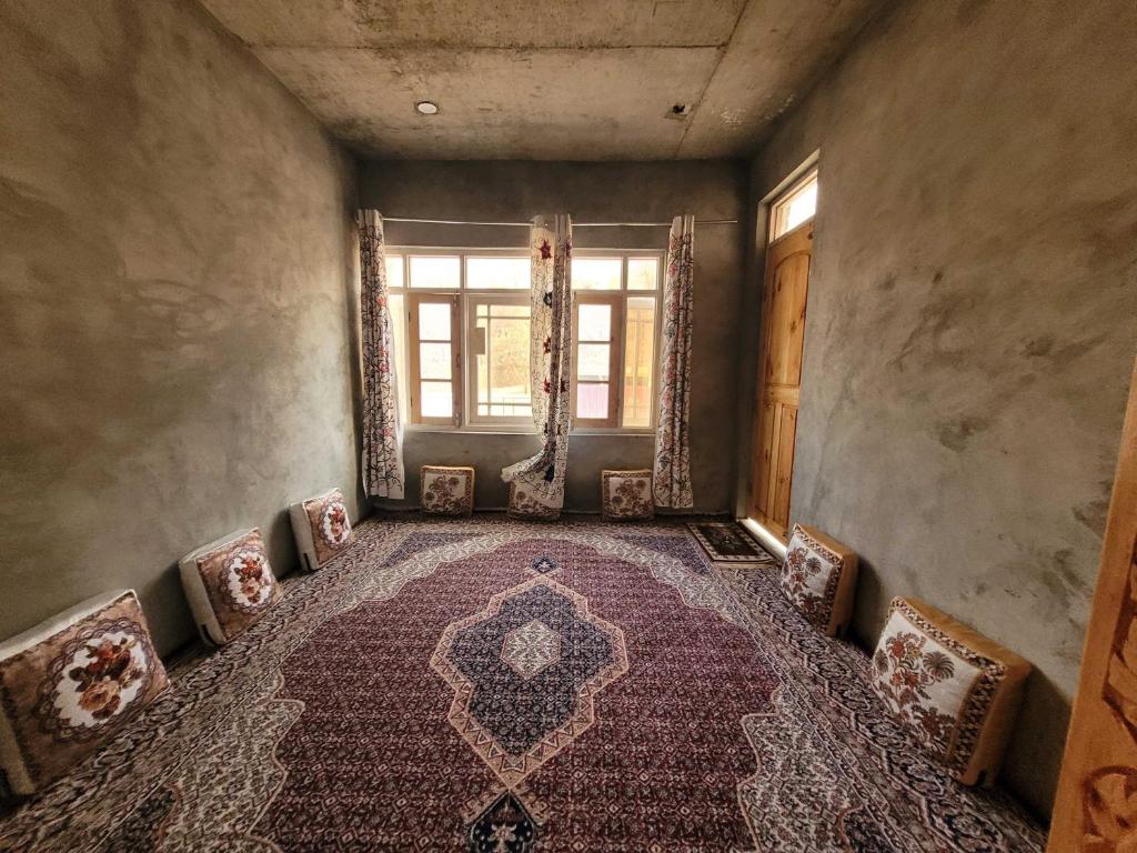 an empty room with a rug and a window at POP Home Sharik Homestay 