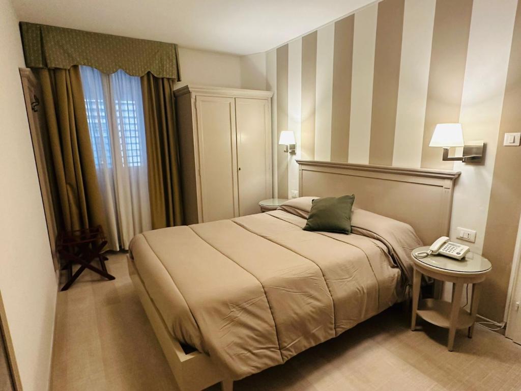 Postel nebo postele na pokoji v ubytování Hotel Bristol