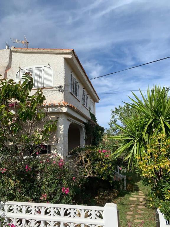 a house with a white fence in front of it at Chalet Las Brisas in Cullera