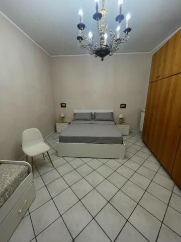 a bedroom with a bed and a chandelier at A Casa re nonn in Naples