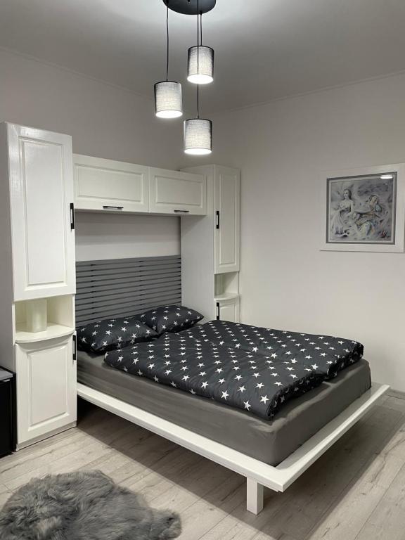 a bedroom with a bed in a white room at M&M apartments in Tivat