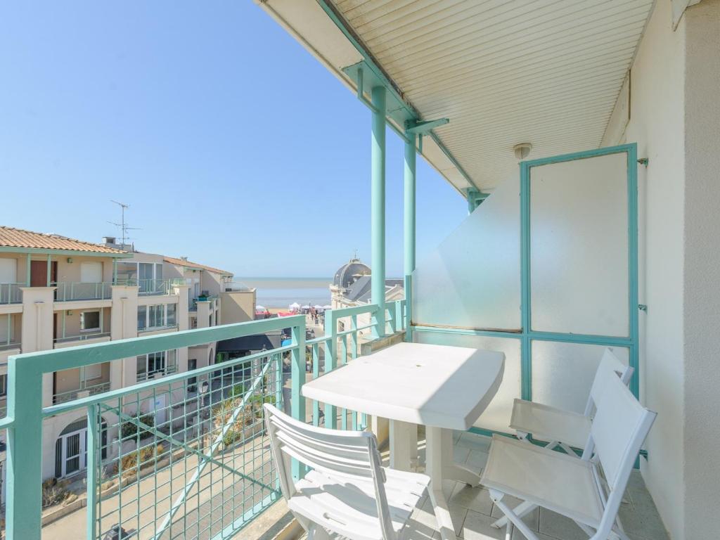 a balcony with a white table and two chairs at Appartement 4 Pers. Terrasse Clim, Piscine Collective - FR-1-535-37 in Châtelaillon-Plage