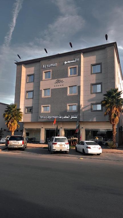 a large building with cars parked in front of it at شقق مساكن السمو المخدومة in Ad Dawādimī
