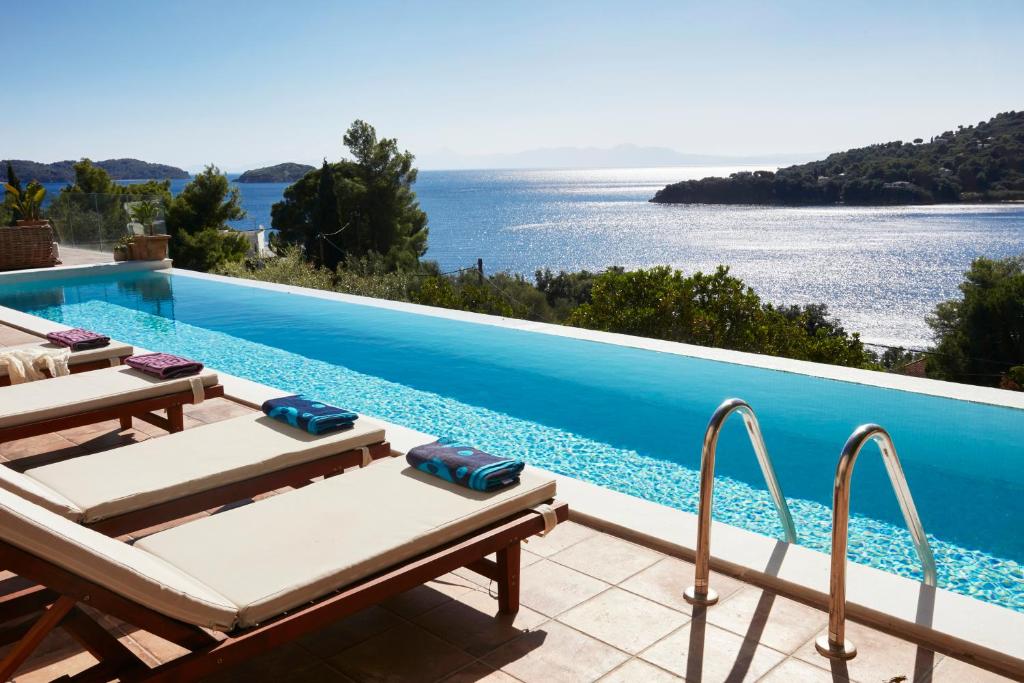a swimming pool with a view of the ocean at Villa Zinnia in Skiathos