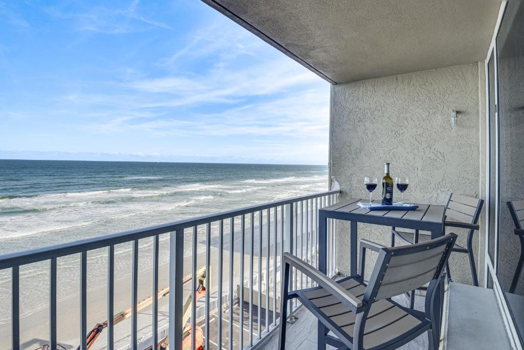a balcony with a table and chairs and the ocean at Daytona Beach Retreat Beach Access! in Daytona Beach