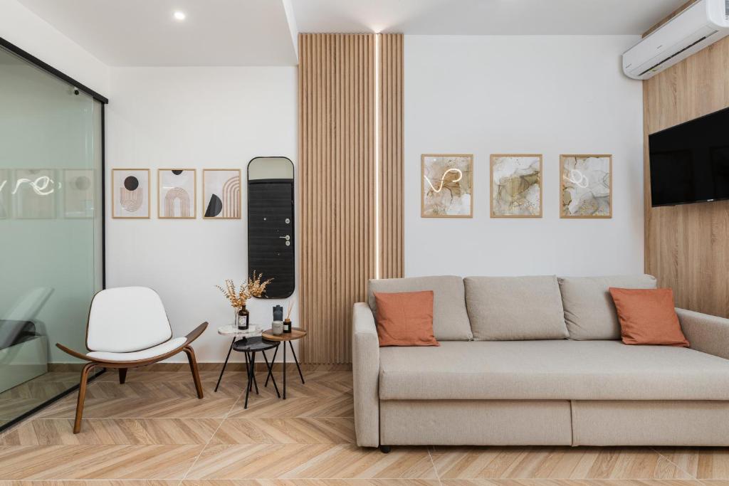 a living room with a couch and a table at Oasis Diamond Suite in Thessaloniki