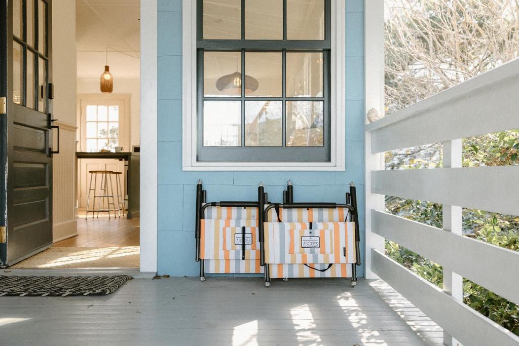 a front porch with a window and a gate at The Bungalow Loft by WB Abodes in Wrightsville Beach