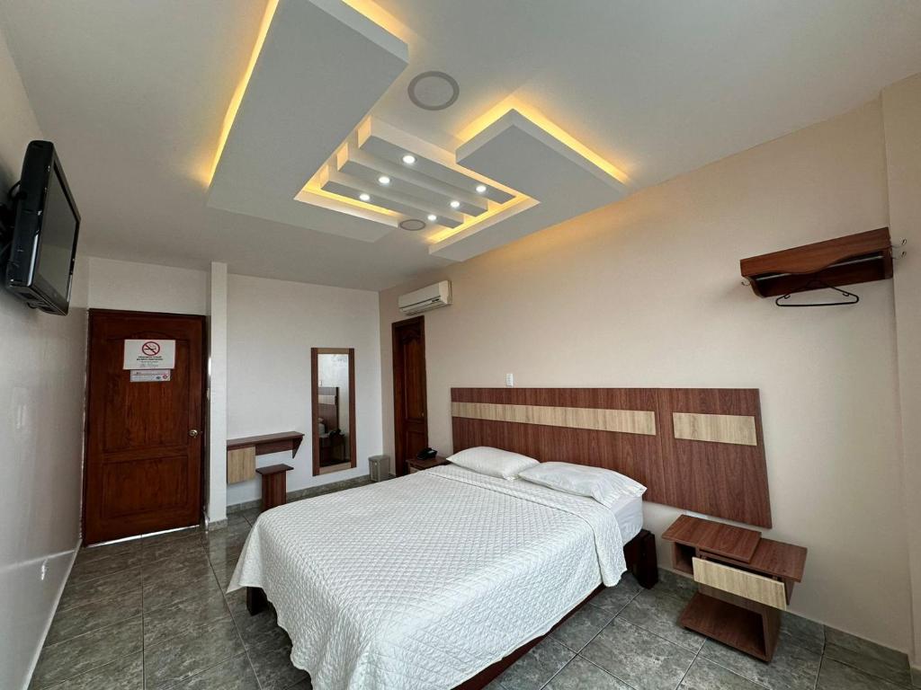 Tempat tidur dalam kamar di Hotel Torre Azul
