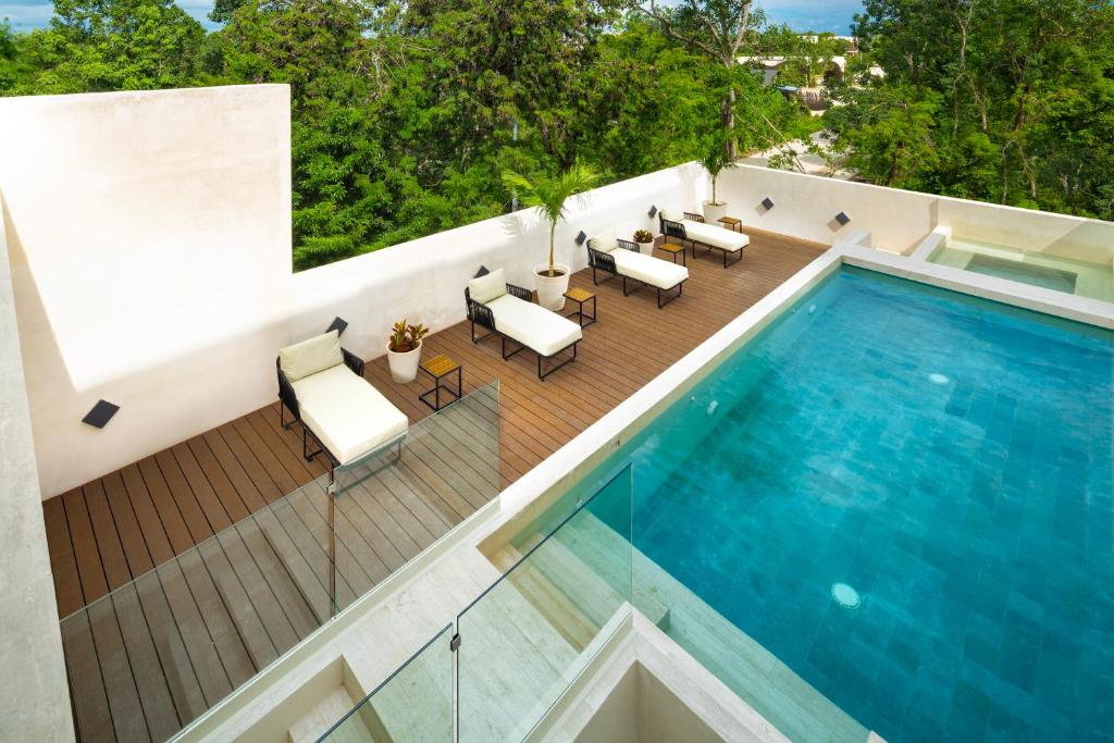 an overhead view of a swimming pool on a house at Bunah Tulum -Distinctive Hotels- in Tulum