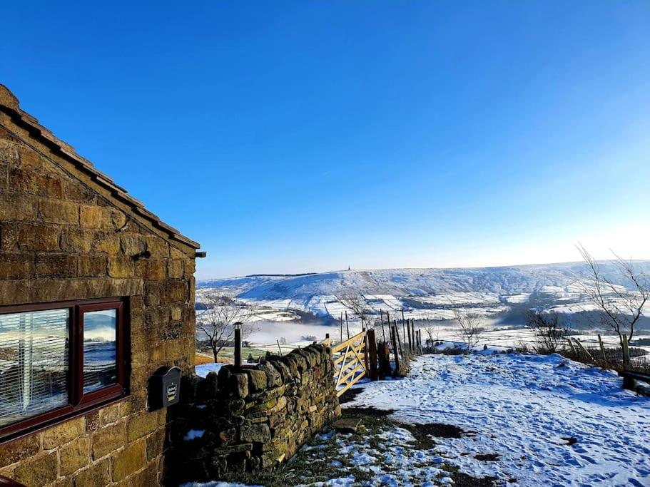 a stone building with snow on the ground at The Studio at Stoodley Pike View in Todmorden
