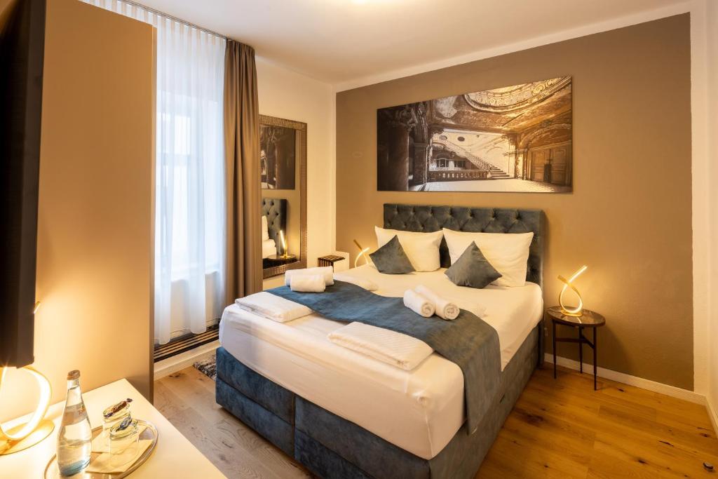 a bedroom with a large bed in a room at Hotel Schwanen in Memmingen