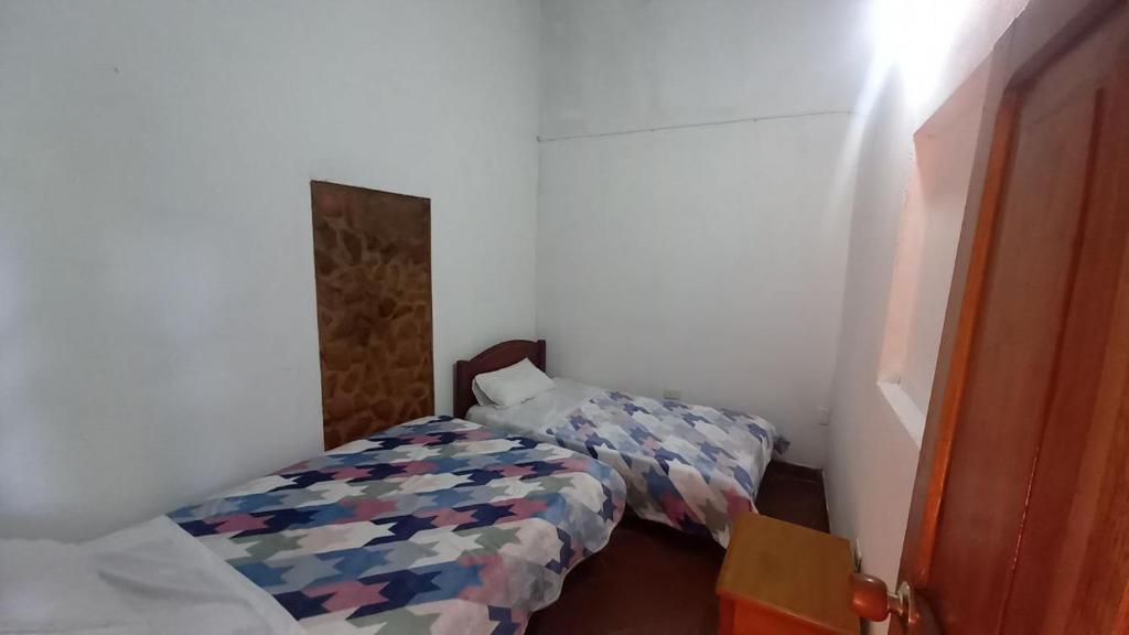 Postel nebo postele na pokoji v ubytování Hostal posada San jose