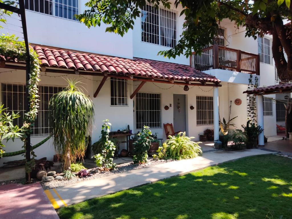 a house with a red roof at Bungalows Teka in Zihuatanejo