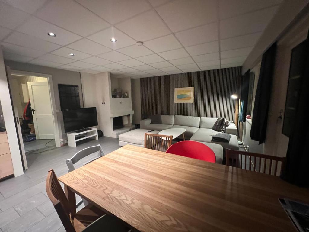 a living room with a table and a couch at Spacious 2-bedroom holiday apartment - Hemsedal Veslehorn 14 in Hemsedal