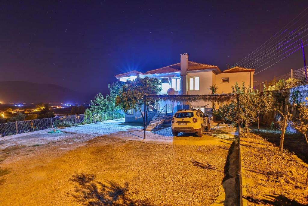 a car parked in front of a house at night at AGACH Apart 1 & 2 in Milas