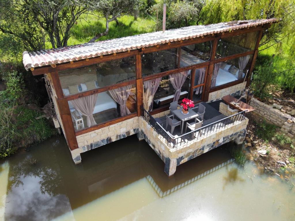 an overhead view of a house on the water at Cabaña Isla Dorada in Guatavita