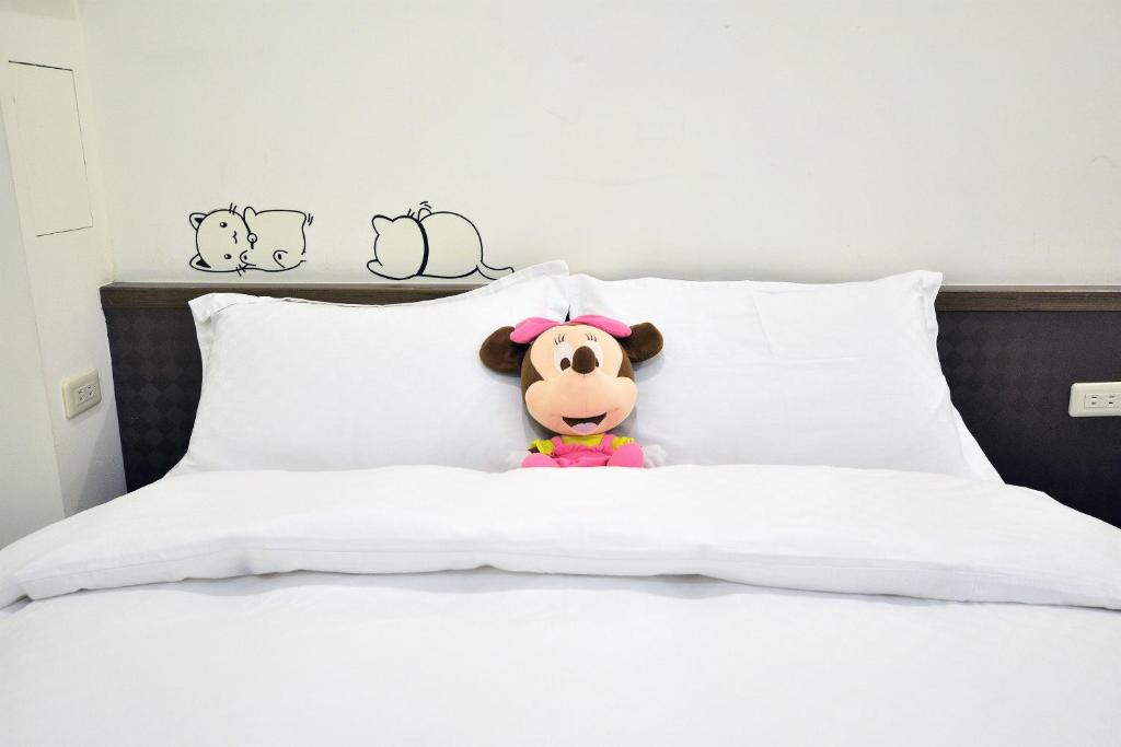 a stuffed animal sitting on top of a bed at Jamie home stay in Taitung City