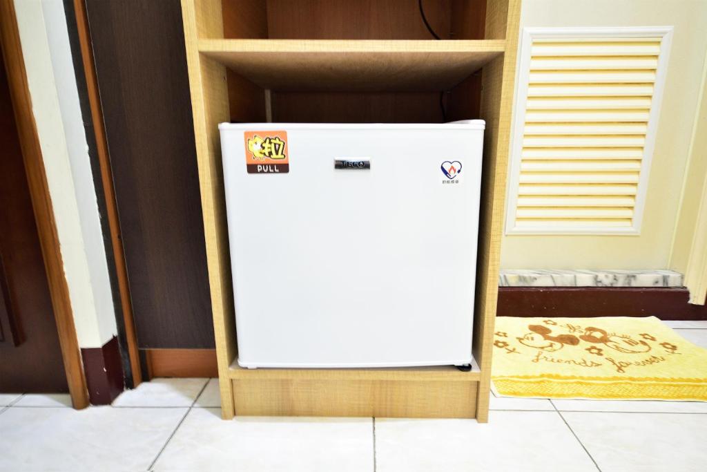 a white refrigerator sitting inside of a closet at Jamie home stay in Taitung City