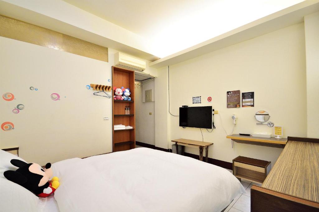a hospital room with a bed and a tv at Jamie home stay in Taitung City