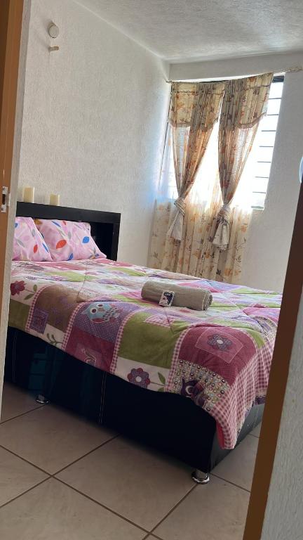 a bed in a bedroom with a window at No vacante in Guadalajara