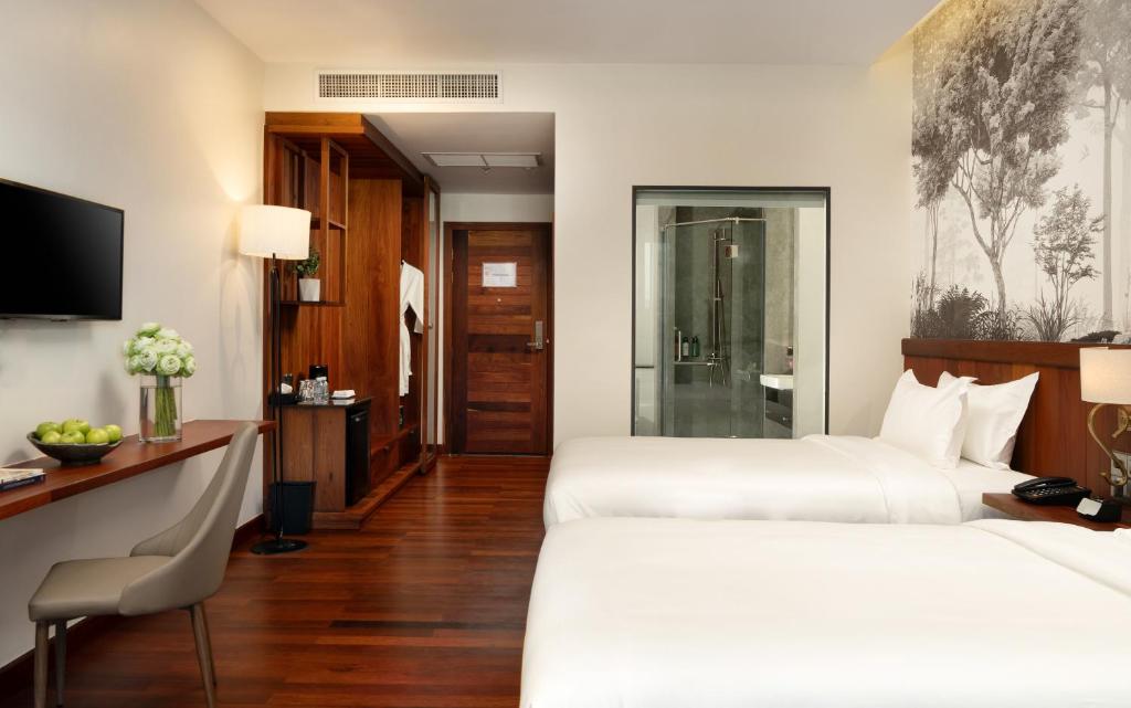 Postel nebo postele na pokoji v ubytování Koulen Central Hotel