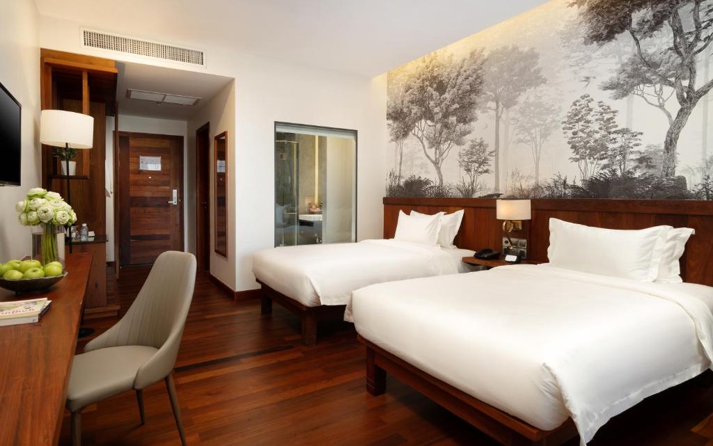 Postel nebo postele na pokoji v ubytování Koulen Central Hotel