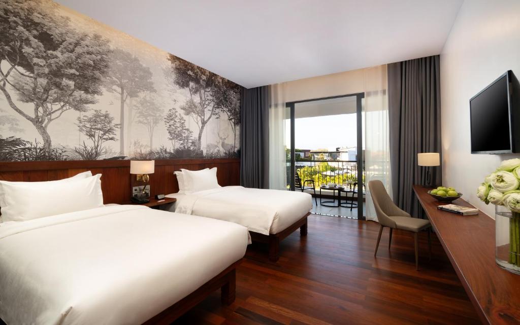 Postel nebo postele na pokoji v ubytování Koulen Central Hotel