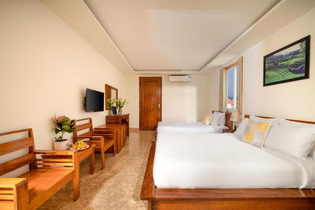 Postel nebo postele na pokoji v ubytování Titan Hotel Da Nang