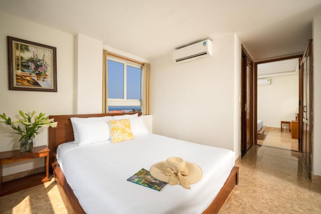 Postel nebo postele na pokoji v ubytování Titan Hotel Da Nang