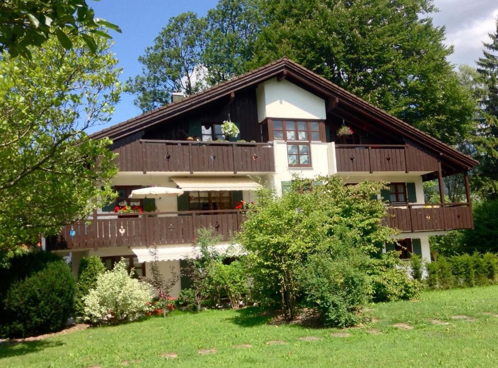 a large house with a balcony and trees at Am Park in Garmisch-Partenkirchen