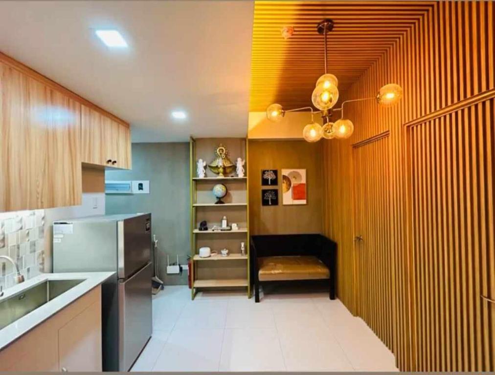 a kitchen with a sink and a refrigerator at Naga City Stylish Condo in Naga