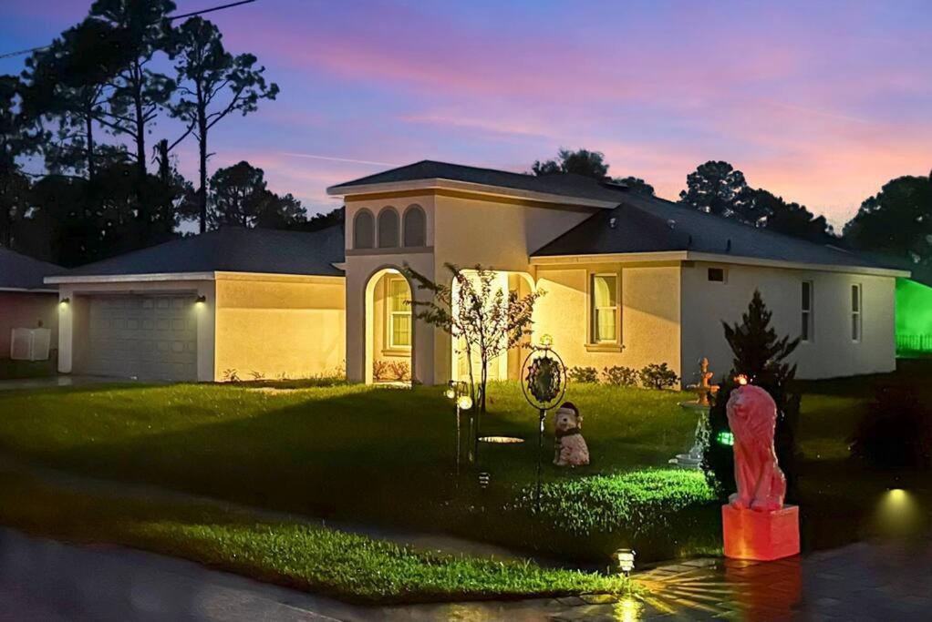 a house with a fire hydrant in front of it at Palm Coast Paradise : Cozy 3BR Vacation Retreat in Palm Coast
